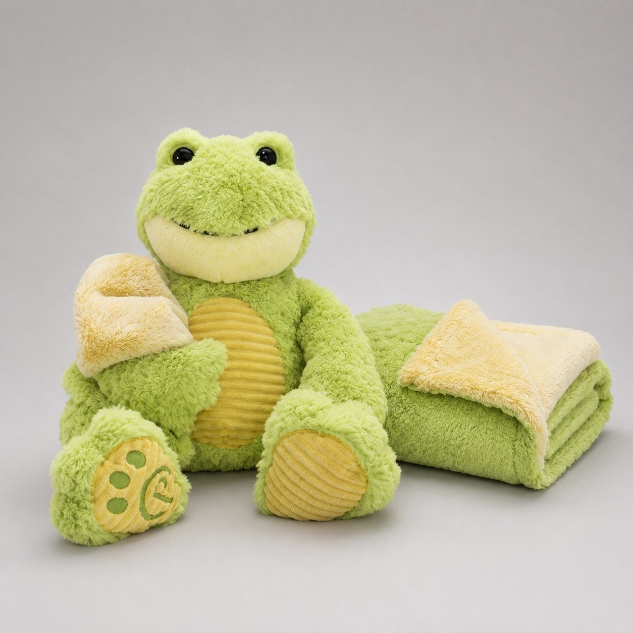 An OrangeOnions green frog plush with a matching fleece blanket