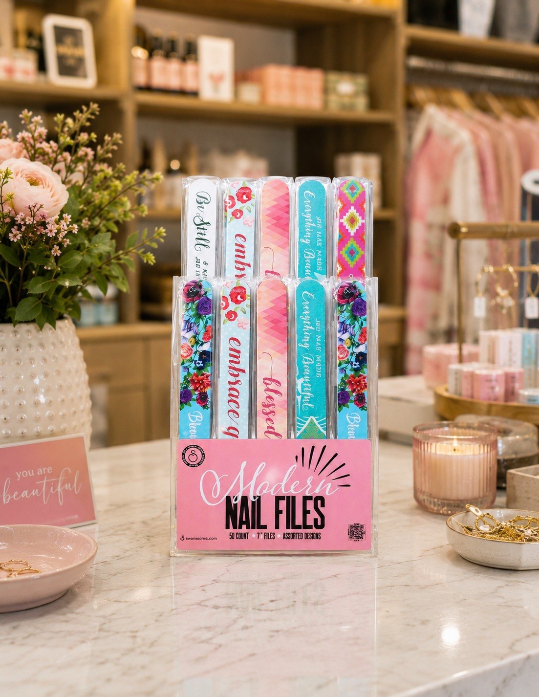 A Modern Nail Files counter display from Swanson Christian Products on a marble counter in a pink boutique