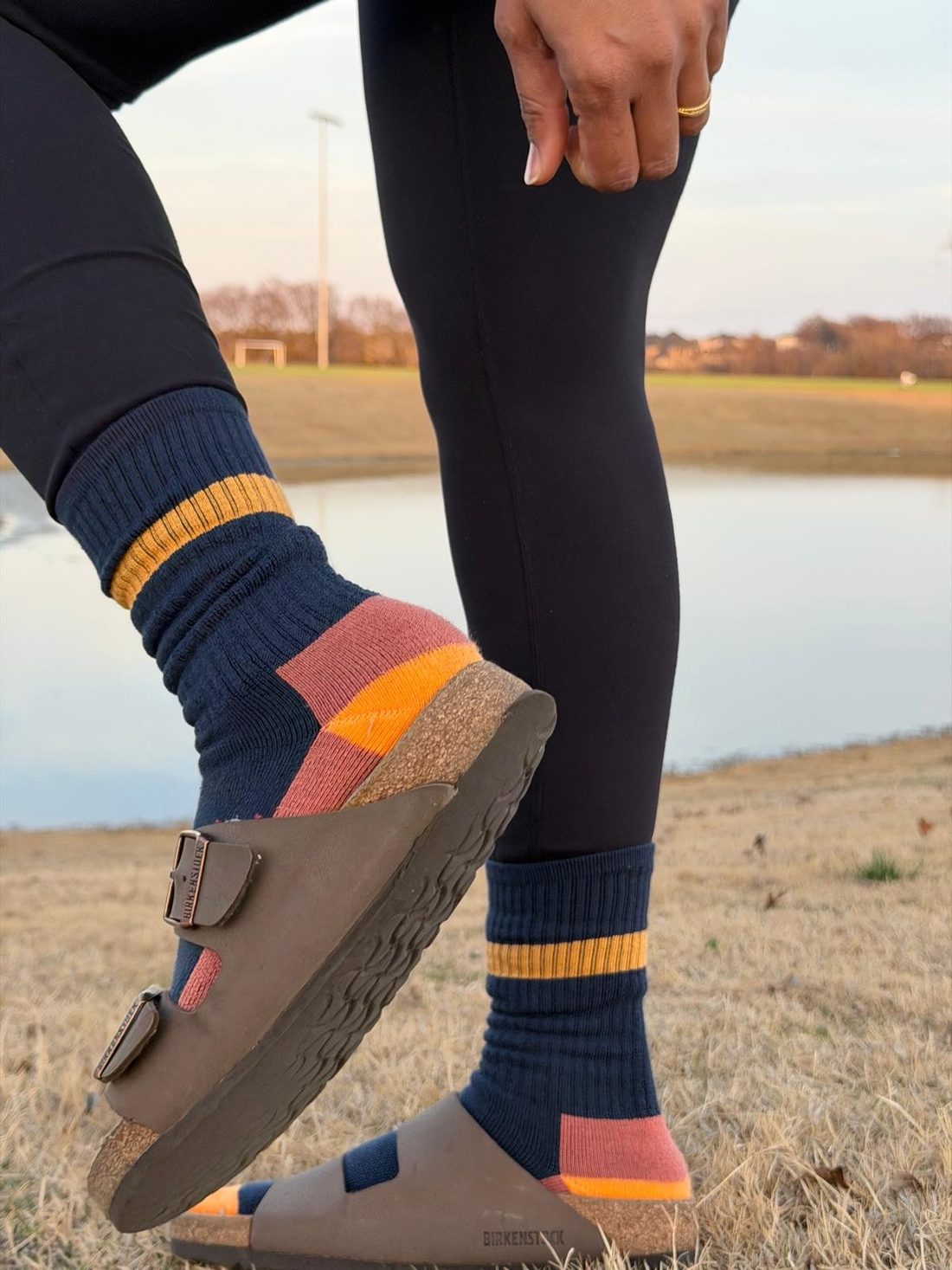 A BiO-G striped crew sock with a cork sandal, lakeside at golden hour